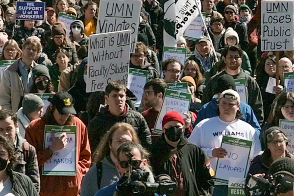Many people at a rally holding signs at University of Minnesota rally