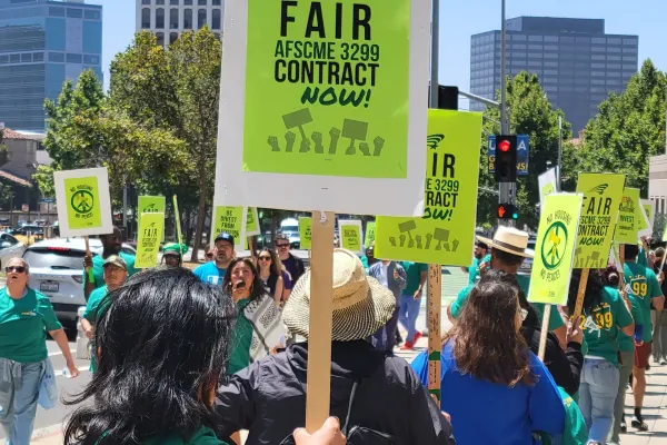 Members of Local 3299 with rally signs that say Fair Contract Now!