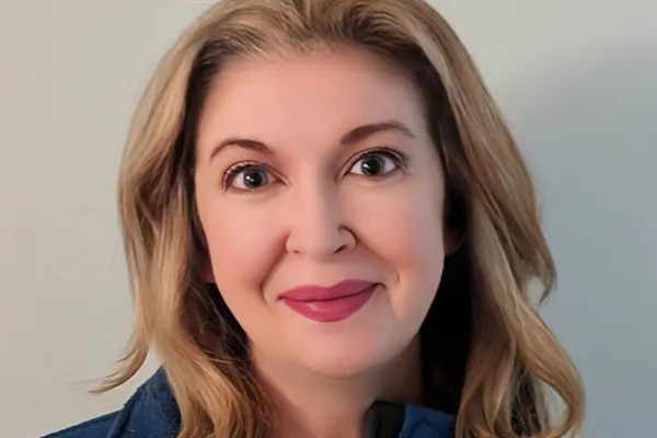 Photo of a white woman with shoulder length blonde hair wearing a blue AFSCME pullover