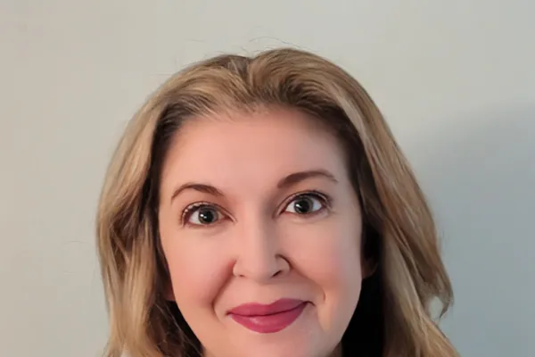 Photo of a white woman with shoulder length blonde hair wearing a blue AFSCME pullover