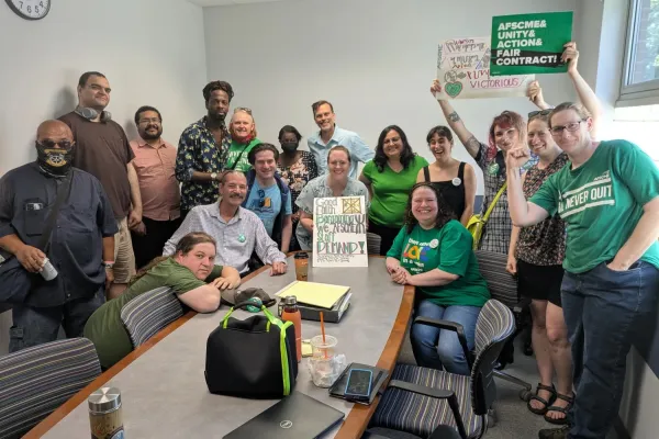 AFSCME members holding signs about fighting for a fair contract