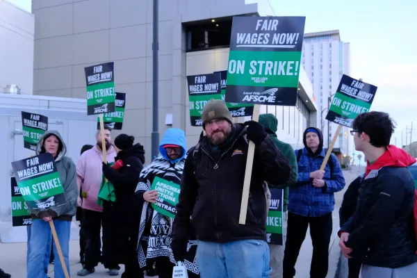 Several AFSCME Council 31 members with signs that say Fair Wages Now, On Strike!