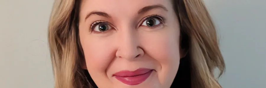 Photo of a white woman with shoulder length blonde hair wearing a blue AFSCME pullover