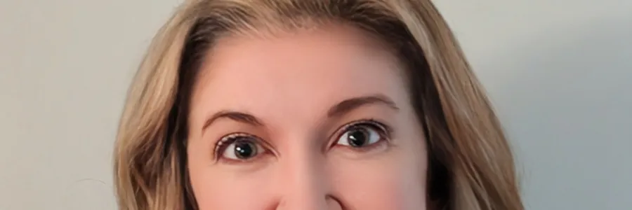 Photo of a white woman with shoulder length blonde hair wearing a blue AFSCME pullover