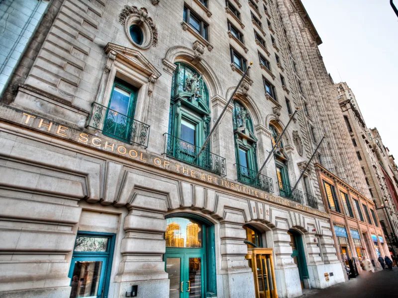 Stone building with oxodized copper features and title The School of the Art Institute across front. Photo Credit: Flickr