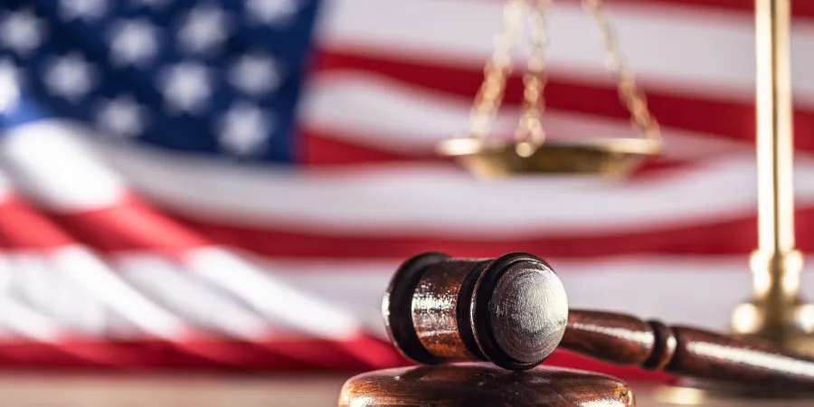Photo of American flag in the background with a gavel in the foreground. Photo credit: Getty Images