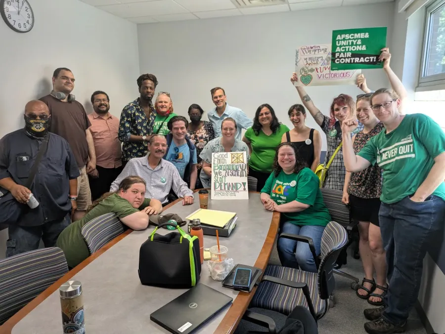 AFSCME members holding signs about fighting for a fair contract