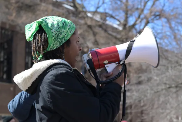Photo of person with a megaphone at rally