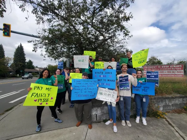 WFSE members with more homemade rally signs with sayings such as Fair Contract Now and Pay Me what you owe me